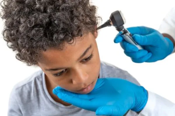 Downloaded Otoscope Examination: Physician performing ear examination during a visit