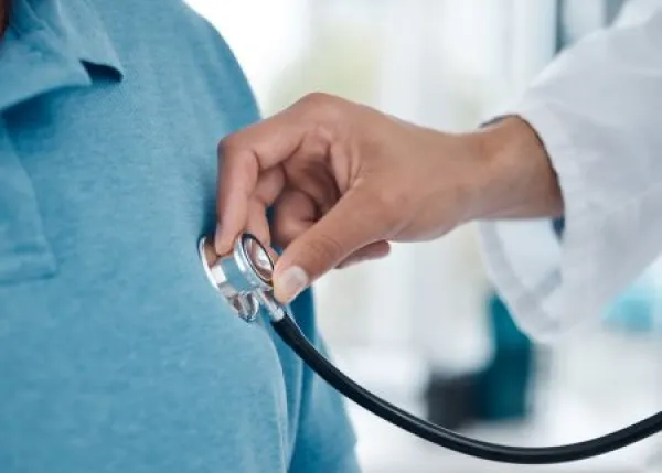 Lets listen to your heartbeat. Shot of an unrecognizable doctor examining a man with a stethoscope in an office.