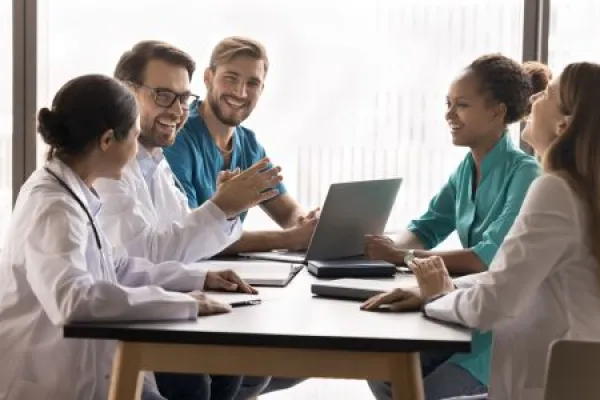 Medical team spirit. Enthusiastic professional young doctors group multiethnic clinic staff collaborate