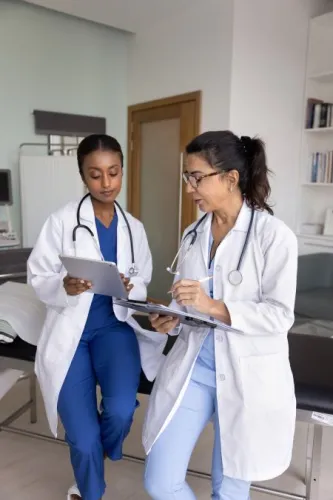 Two healthcare professionals working together in clinic office