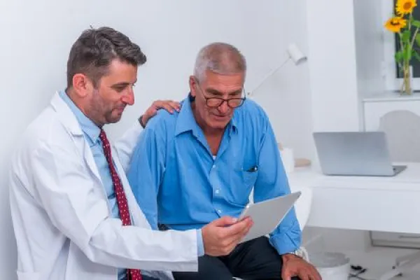 practitioner talking to older patient