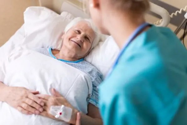 Senior patient and nurse in hospital