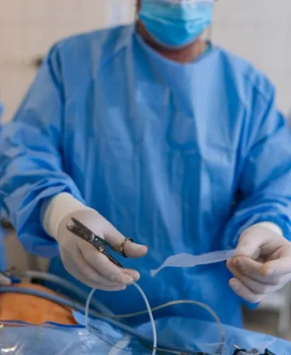 Surgeon cutting surgical mesh for hernia repair surgery
