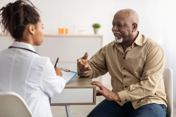 Black patient talking to doctor during appointment 