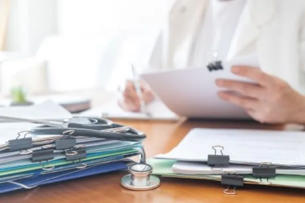 Downloaded Healthcare personnel managing medical records, documents, and patient files