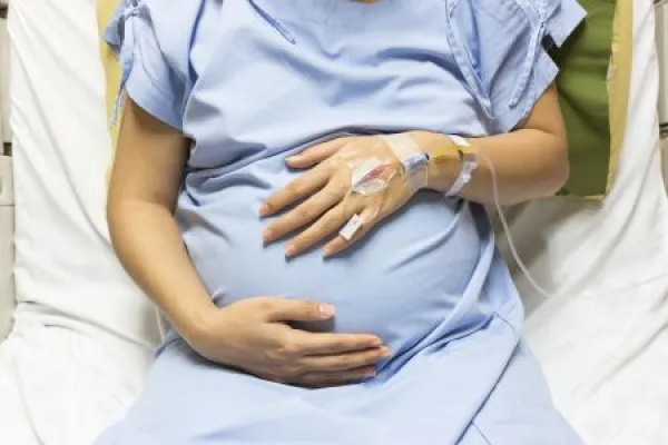 Asian Pregnant Woman patient is on drip receiving a saline solut