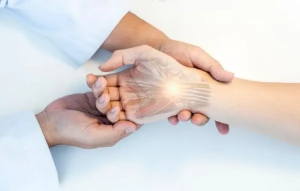 The orthopedic doctor or surgeon in uniform examined the patient with numbness of hand.Wrist pain in carpal