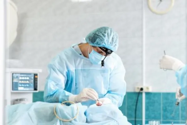 Male otolaryngologist performs septoplasty rhinoplasty in the operating room