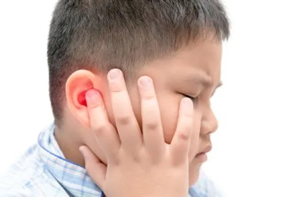 boy holding his ear