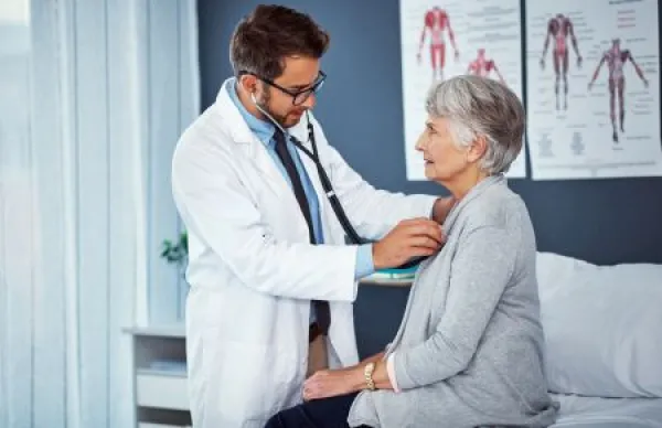 Stethoscope, doctor and medical with old woman in hospital for checkup, lung assessment and consulting.