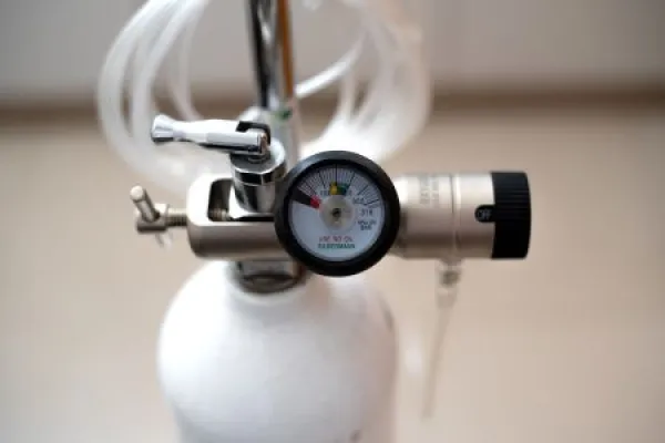 oxygen cannister with gauge and nasal cannula tubing