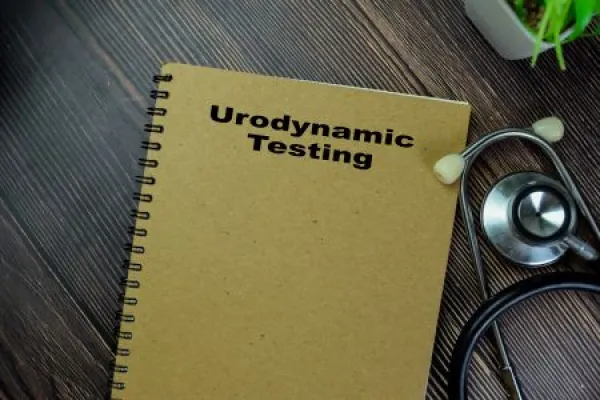Concept of Urodynamic Testing write on book with stethoscope isolated on Wooden Table.